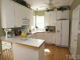 5809 Ventry Court Raleigh, NC 27613 - Photo 7 of 9 a kitchen with a refrigerator and a sink