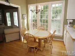 5809 Ventry Court Raleigh, NC 27613 - Photo 9 of 9 a view of a dining room with furniture window and wooden floor
