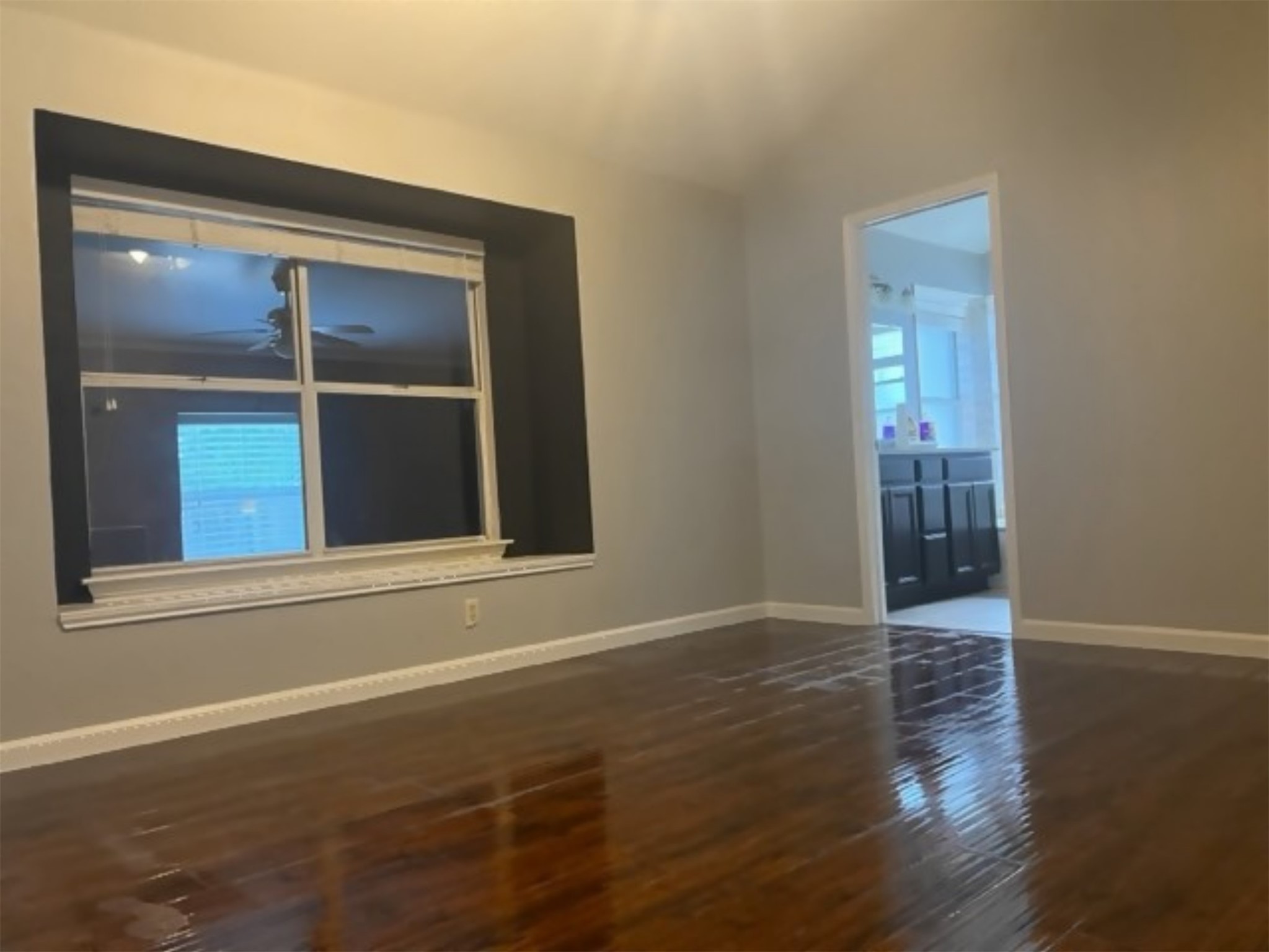 5611 Meadow Crest Austin, TX 78744 - Photo 11 of 26 Empty room with dark wood finished floors and vaulted ceiling