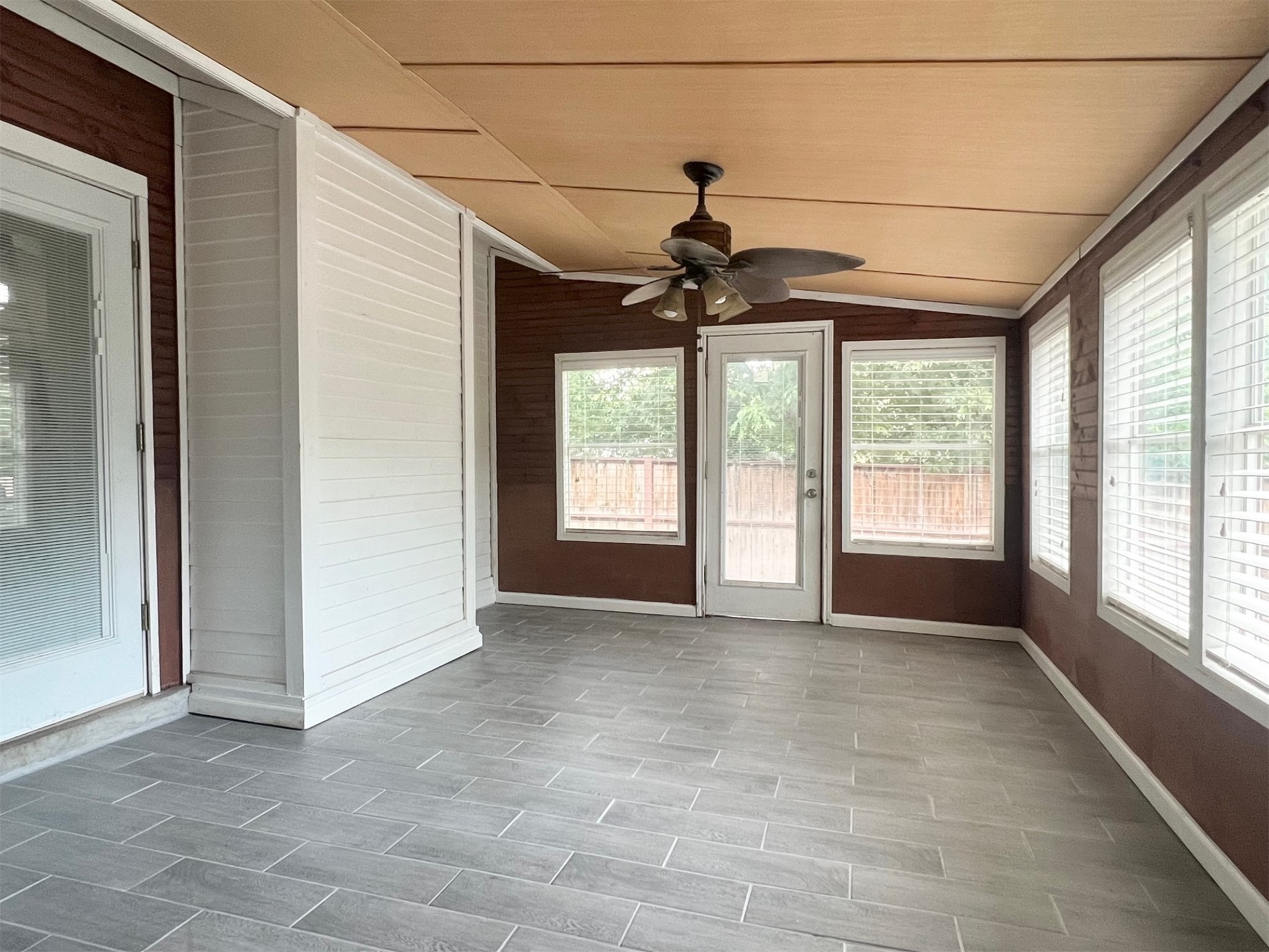 5611 Meadow Crest Austin, TX 78744 - Photo 22 of 26 Unfurnished sunroom featuring ceiling fan and lofted ceiling