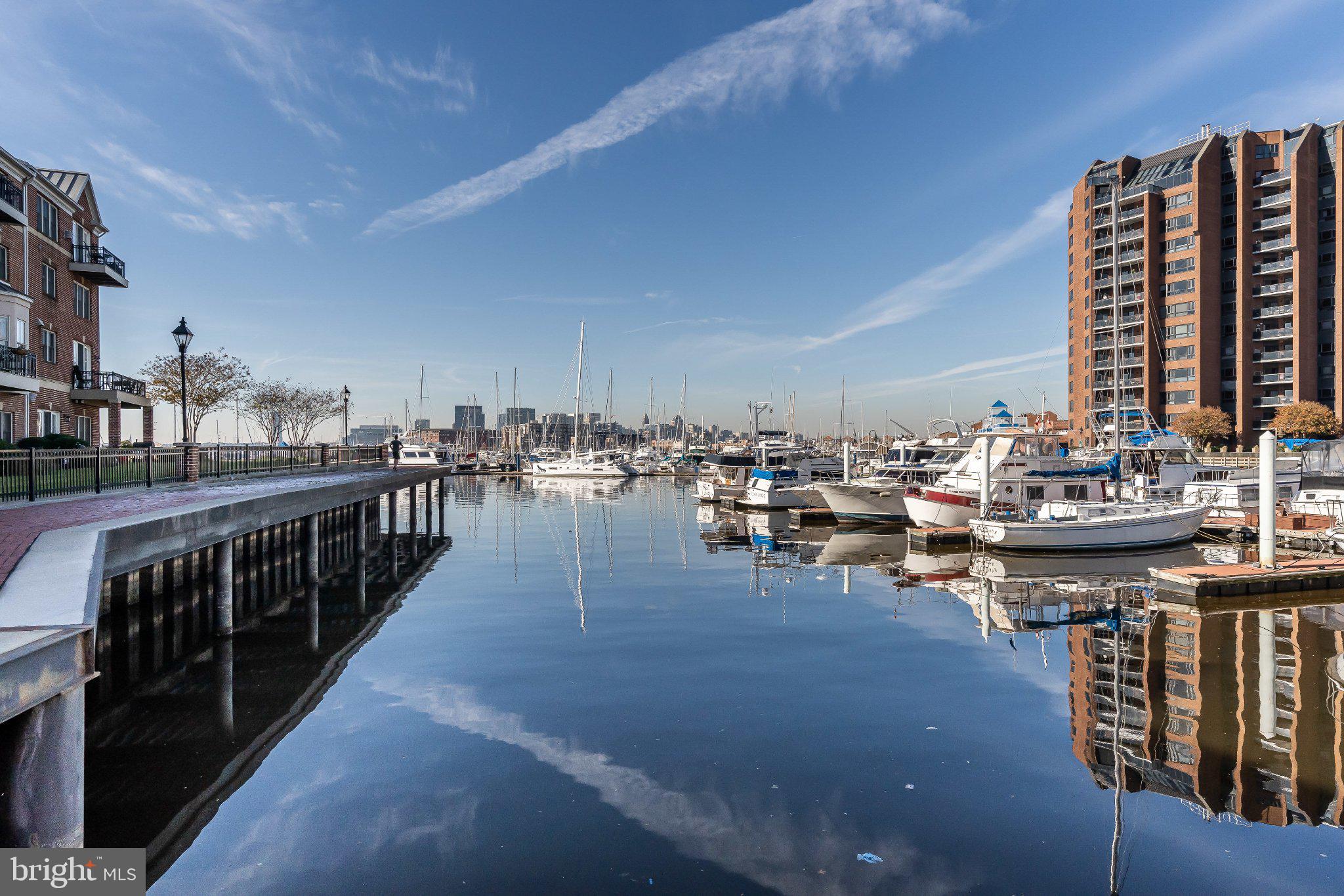 2702 Lighthouse Point East, Unit 532 Baltimore, MD 21224 - Photo 40 of 41 Serene marina under a clear sky.
