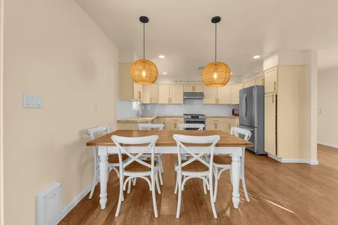 a view of a dining room with furniture wooden floor and chandelier