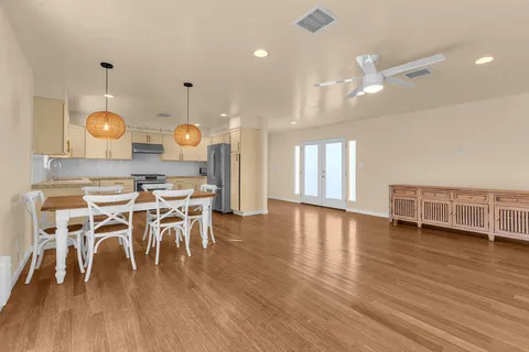 a view of a dining room with furniture and wooden floor