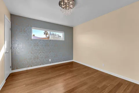 a view of a room with wooden floor and a window