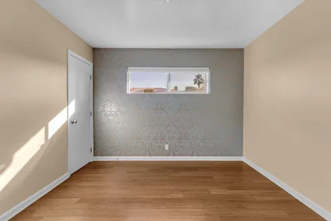a view of a room with wooden floor