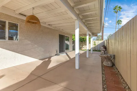 a view of a swimming pool with outdoor seating and plants