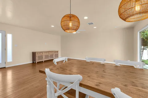 a view of a dining room with furniture and wooden floor