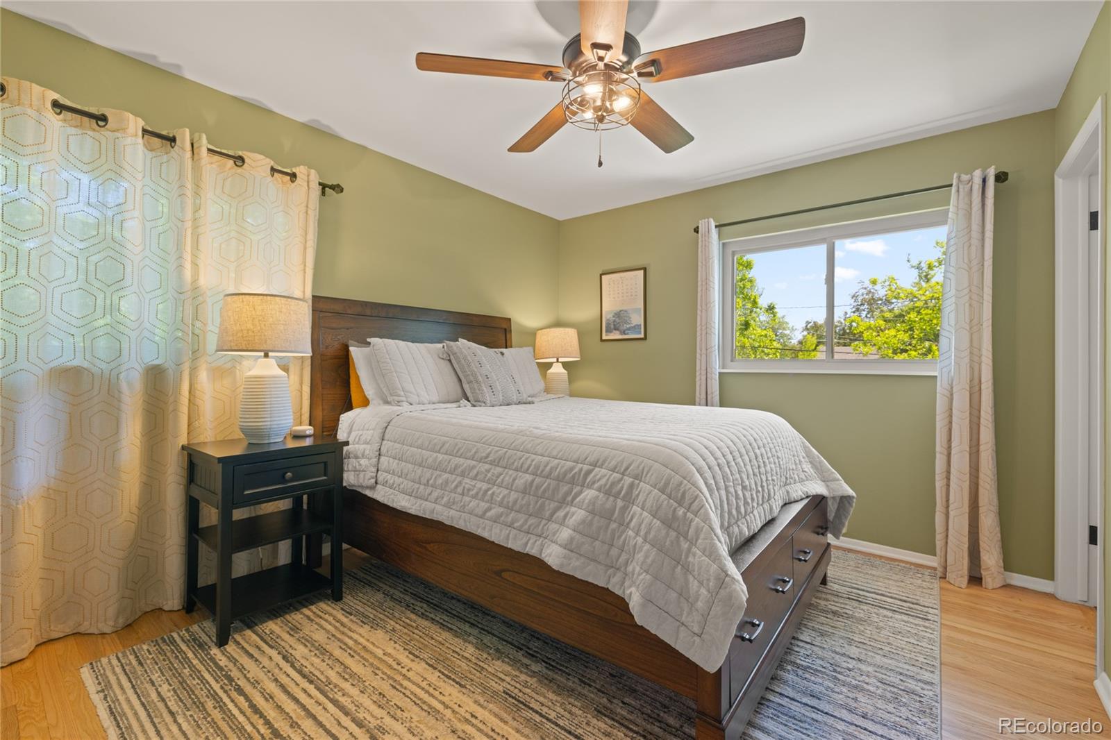 13402 West 24th Place Golden, CO 80401 - Photo 14 of 38 a bedroom with a bed wooden floor and window