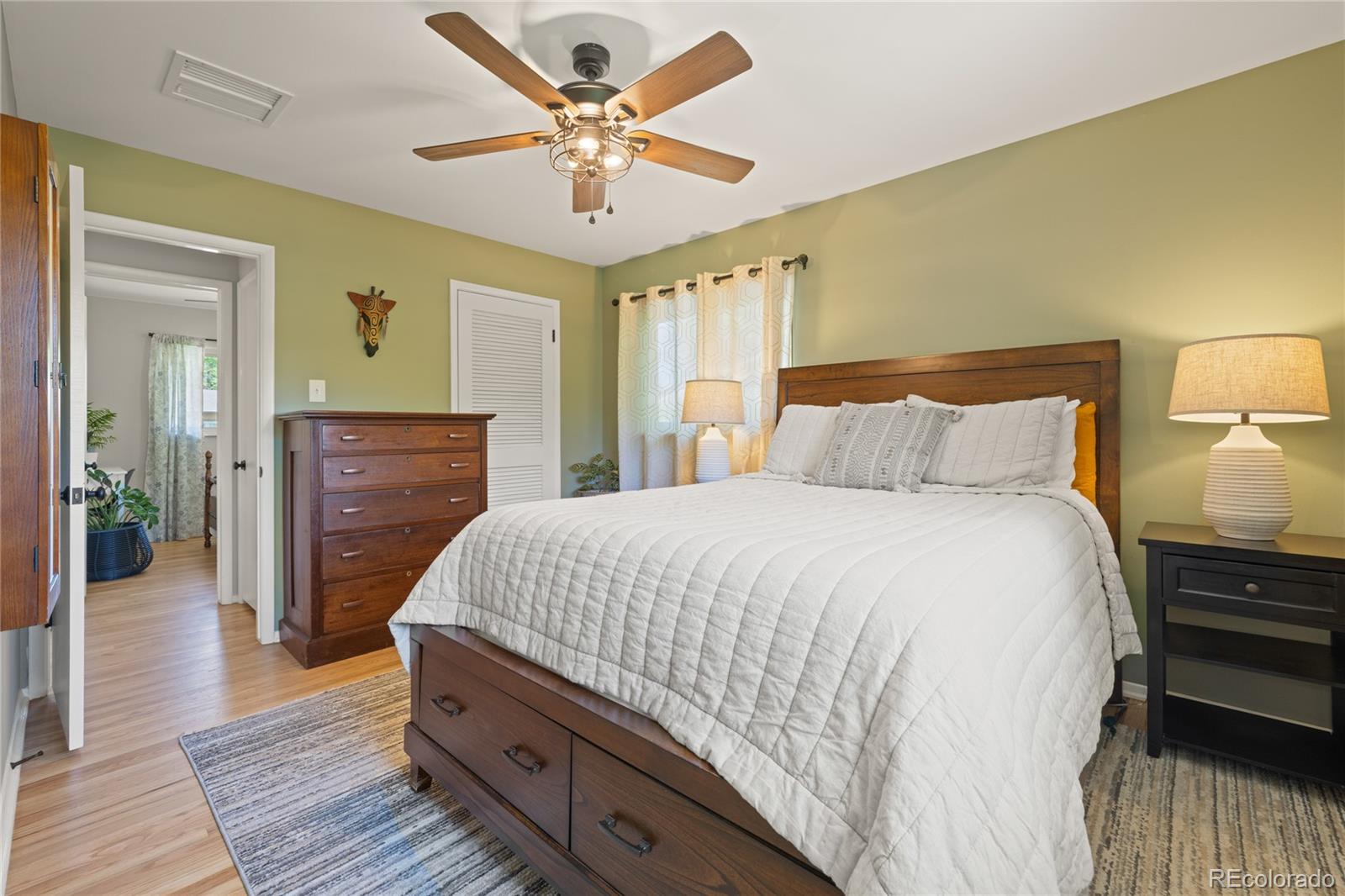 13402 West 24th Place Golden, CO 80401 - Photo 15 of 38 a bedroom with a bed and wooden floor