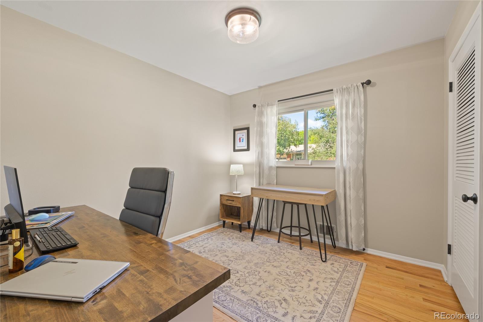 13402 West 24th Place Golden, CO 80401 - Photo 19 of 38 a bed room with furniture and a window