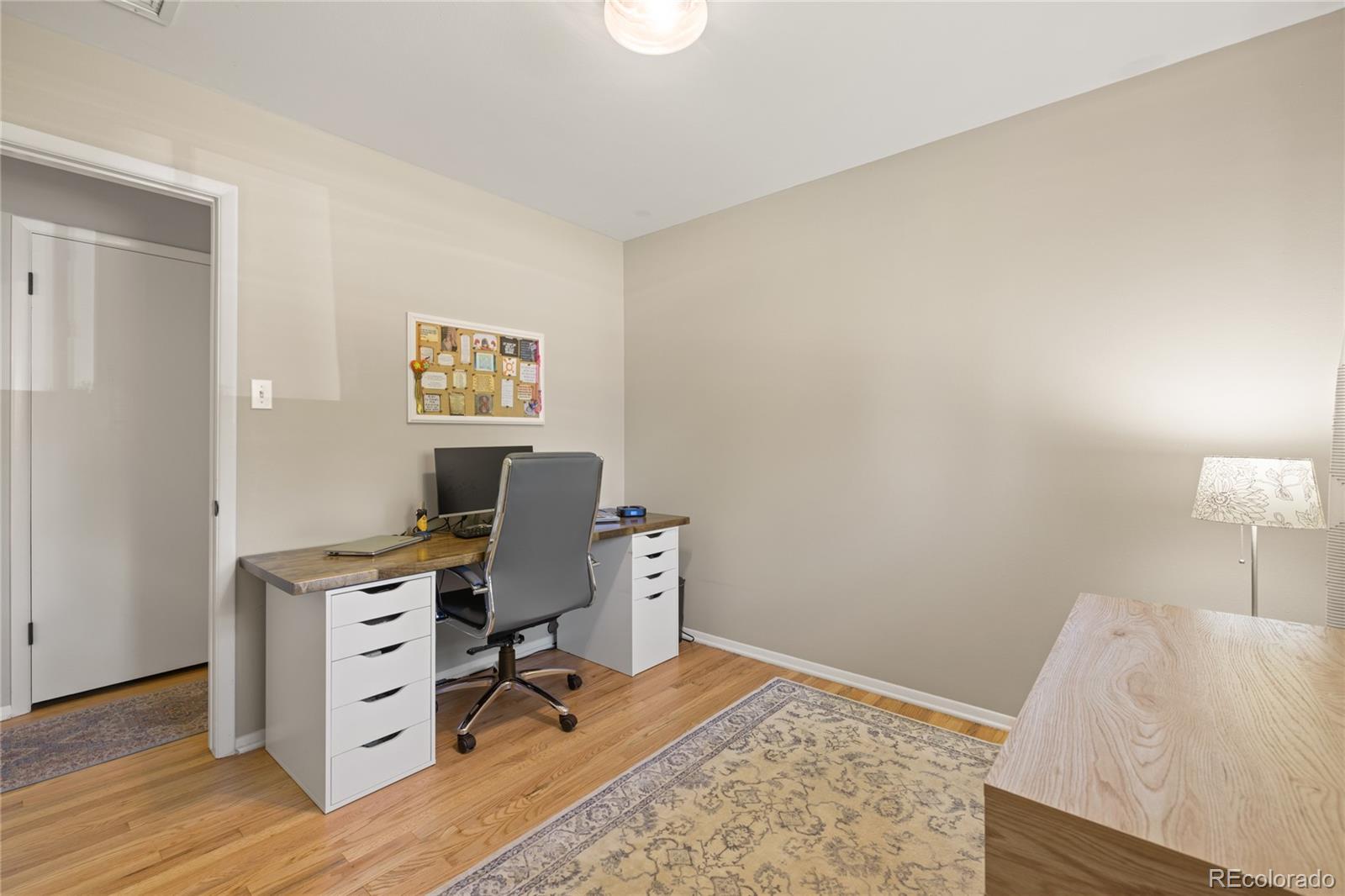 13402 West 24th Place Golden, CO 80401 - Photo 20 of 38 a view of a workspace with furniture and wooden floor