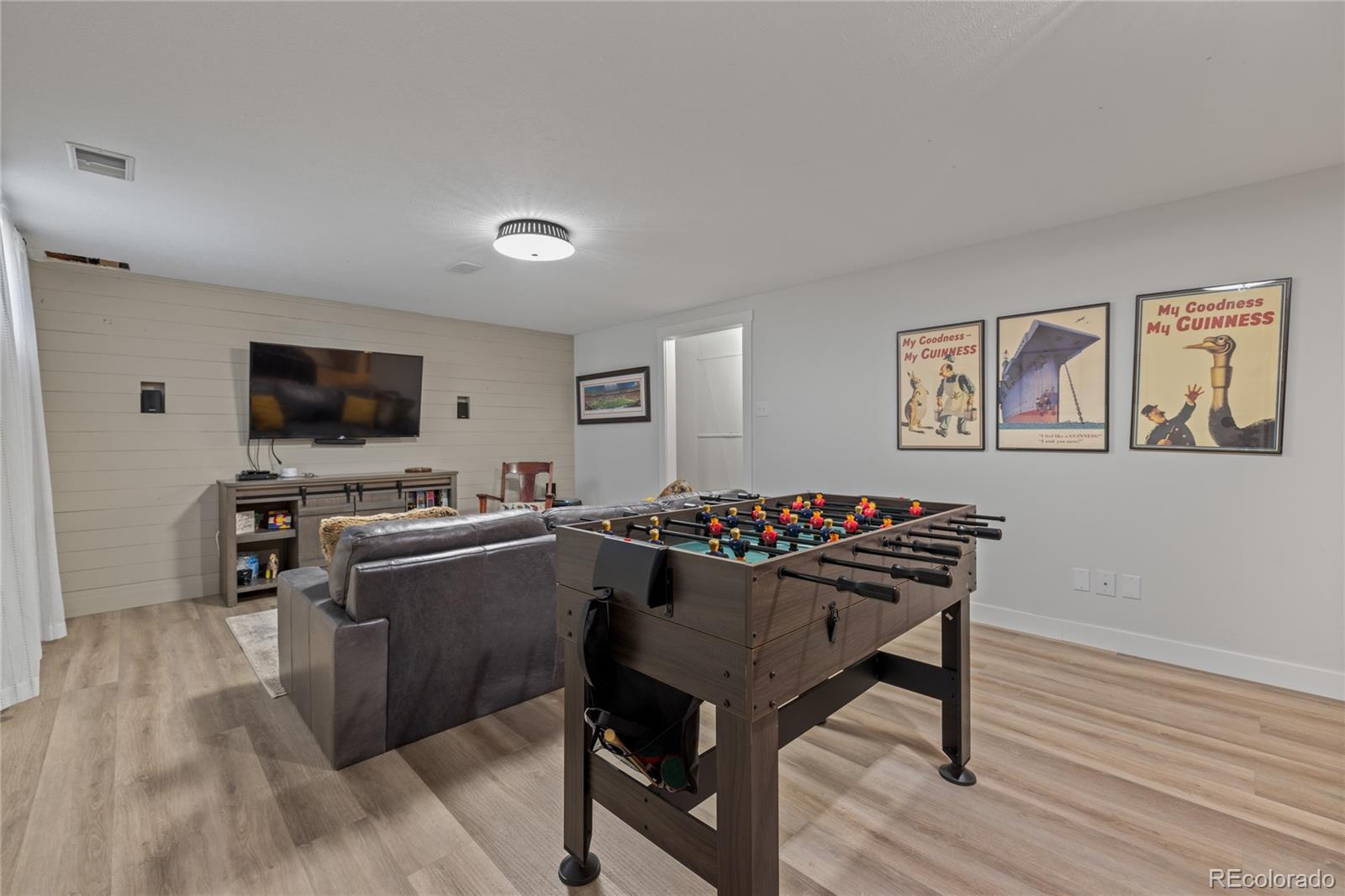 13402 West 24th Place Golden, CO 80401 - Photo 22 of 38 a living room with furniture and a flat screen tv