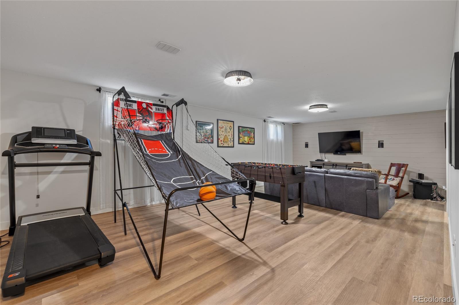 13402 West 24th Place Golden, CO 80401 - Photo 24 of 38 a living room with furniture and a flat screen tv