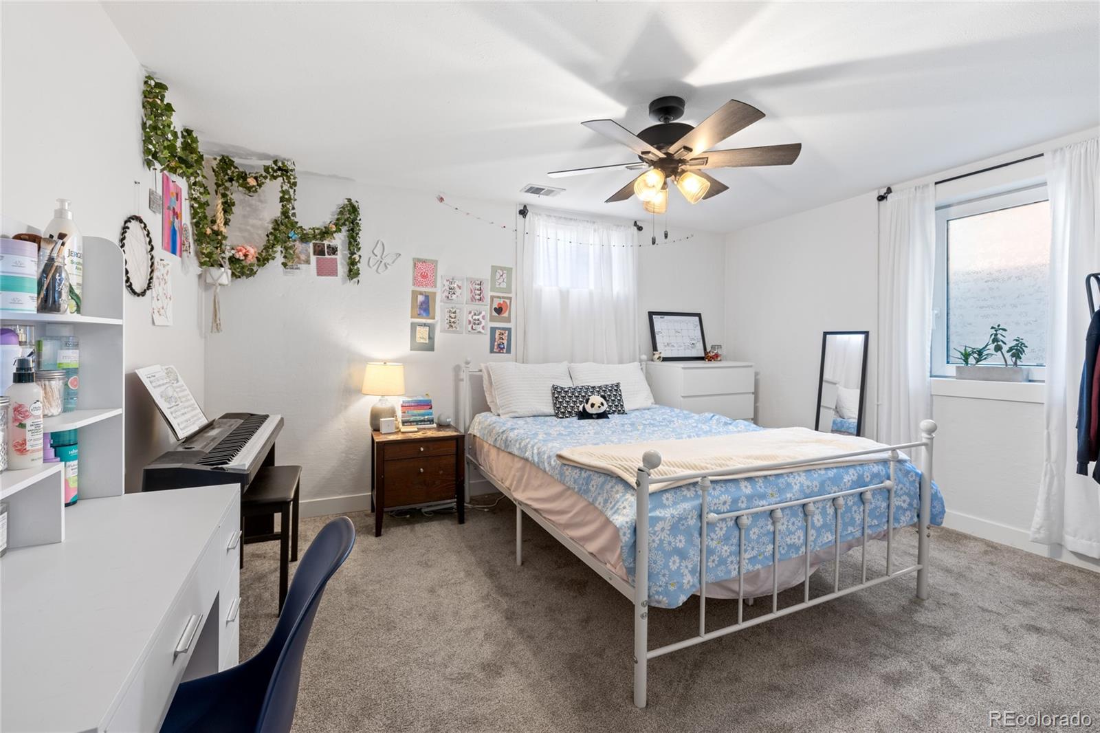 13402 West 24th Place Golden, CO 80401 - Photo 25 of 38 a bedroom with a bed and a chandelier