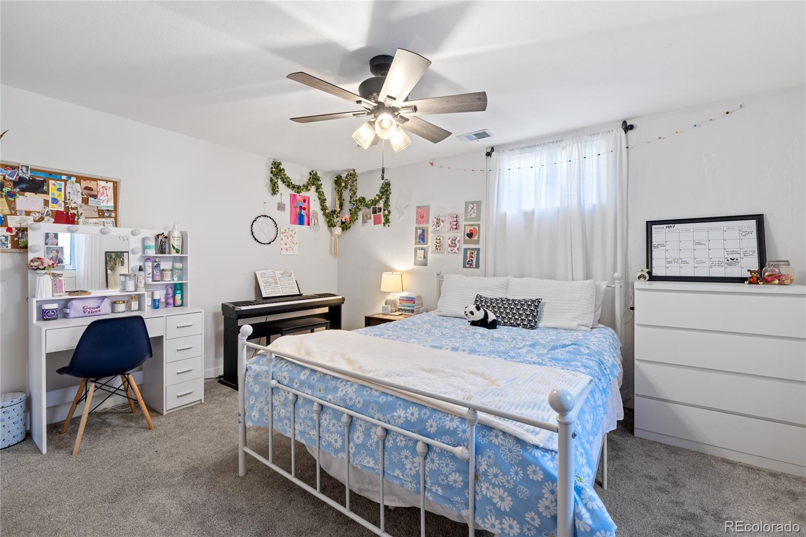 13402 West 24th Place Golden, CO 80401 - Photo 26 of 38 a bedroom with a bed a computer on a desk and a dresser