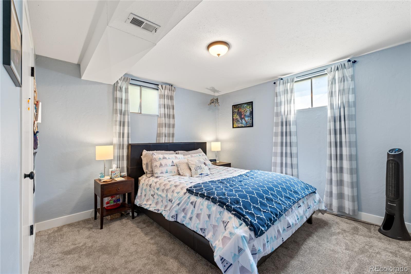 13402 West 24th Place Golden, CO 80401 - Photo 27 of 38 a bedroom with a bed and a table in it
