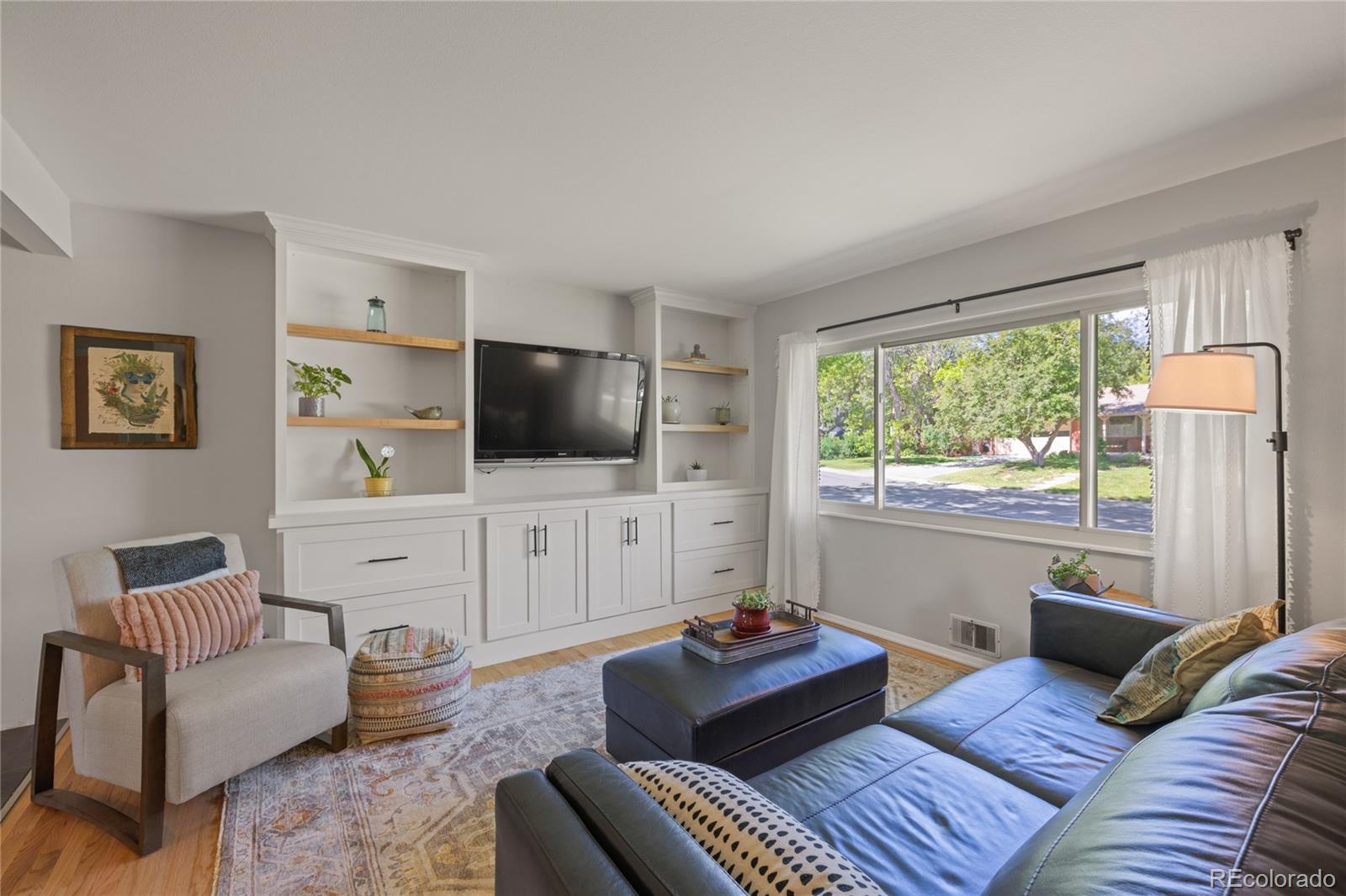 13402 West 24th Place Golden, CO 80401 - Photo 3 of 38 a living room with furniture and a flat screen tv