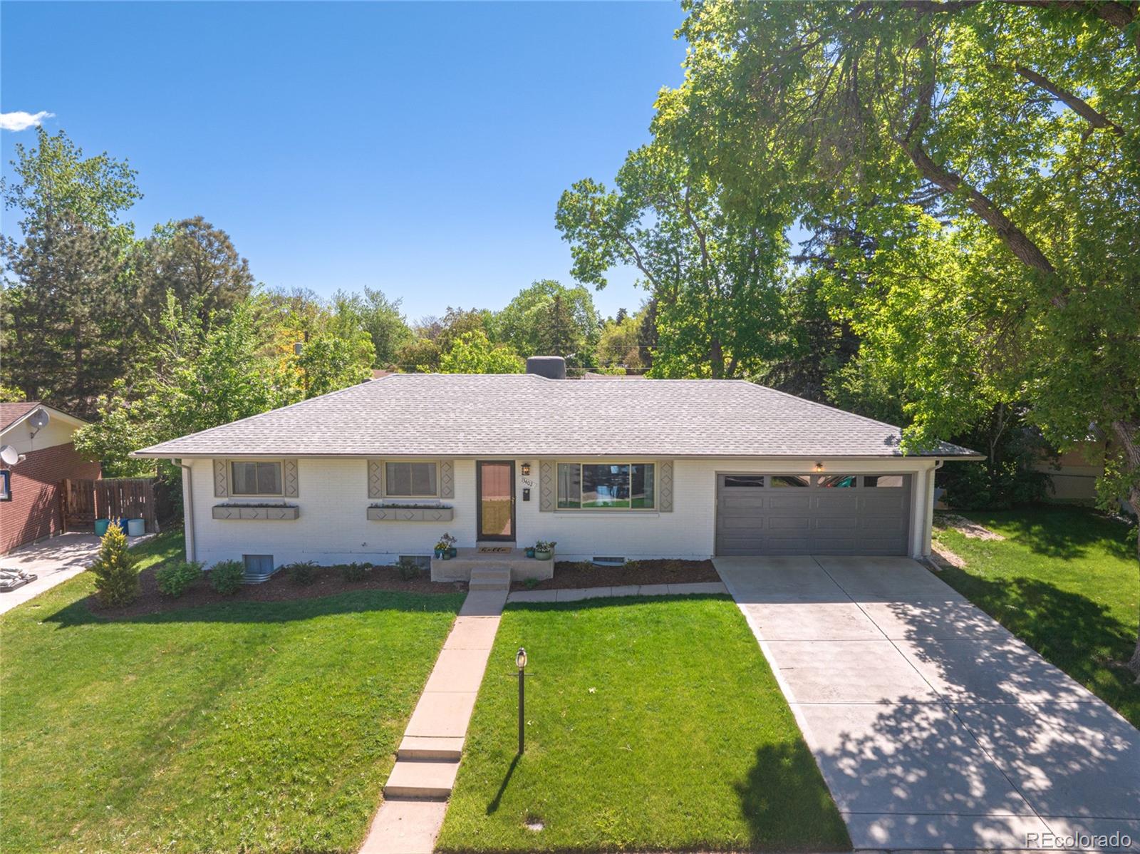 13402 West 24th Place Golden, CO 80401 - Photo 36 of 38 a aerial view of a house with a yard table and chairs