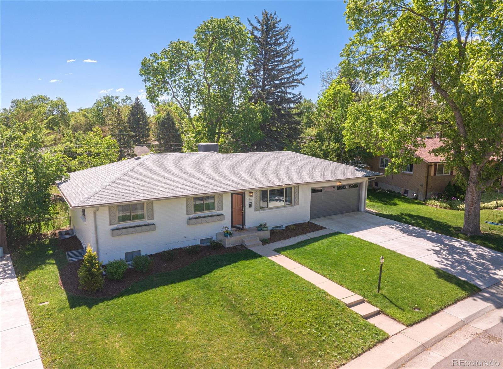 13402 West 24th Place Golden, CO 80401 - Photo 37 of 38 a aerial view of a house next to a big yard and large trees