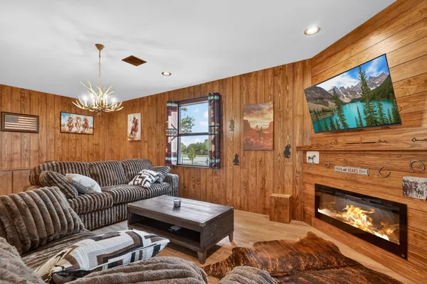 a living room with furniture a flat screen tv and a fireplace