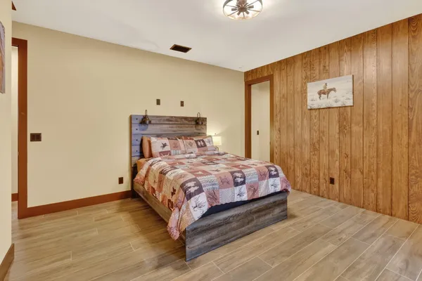 a bed sitting in a bedroom next to a wooden door