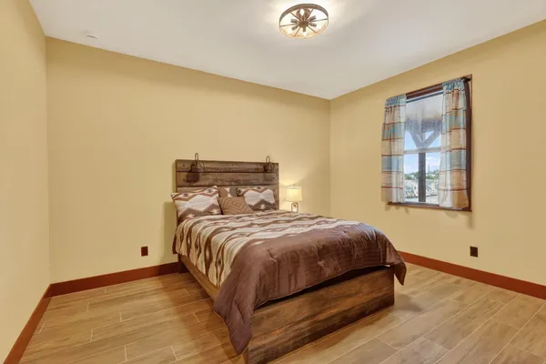 a bedroom with a bed and wooden floor
