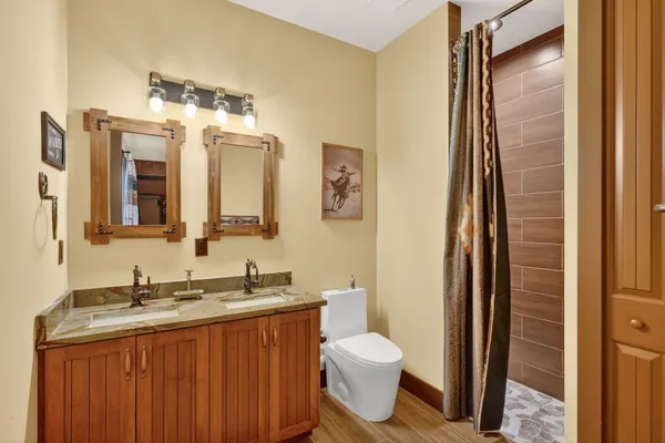 a bathroom with a granite countertop sink toilet and shower