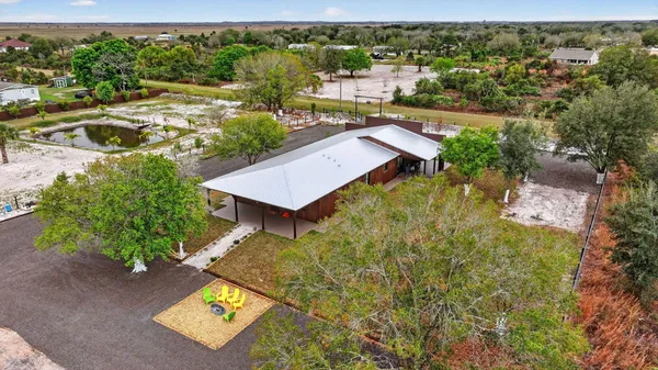 an aerial view of a house with a yard