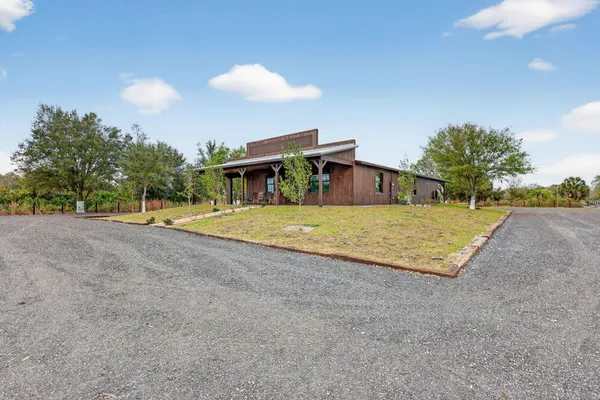 a view of a house with a backyard
