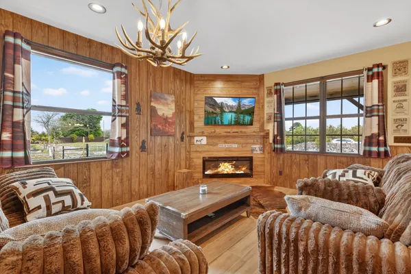 a living room with furniture fireplace and flat screen tv