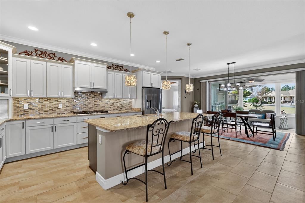 9630 Southwest 86th Place Ocala, FL 34481 - Photo 8 of 42 a kitchen with stainless steel appliances granite countertop table chairs sink and cabinets