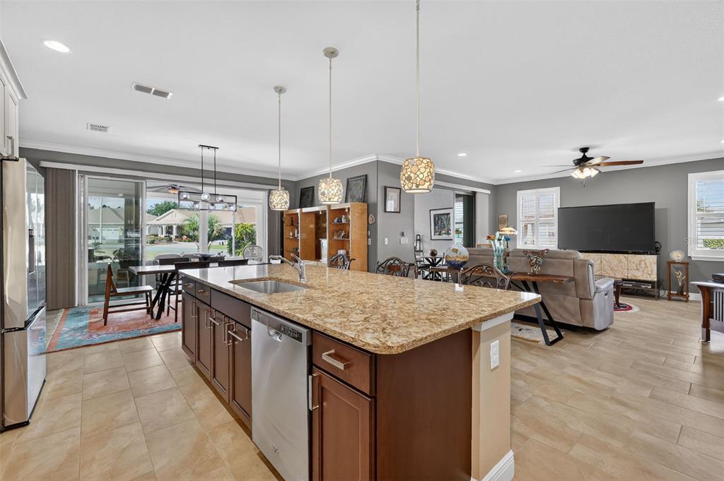 9630 Southwest 86th Place Ocala, FL 34481 - Photo 10 of 42 a open kitchen with stainless steel appliances granite countertop a stove and refrigerator