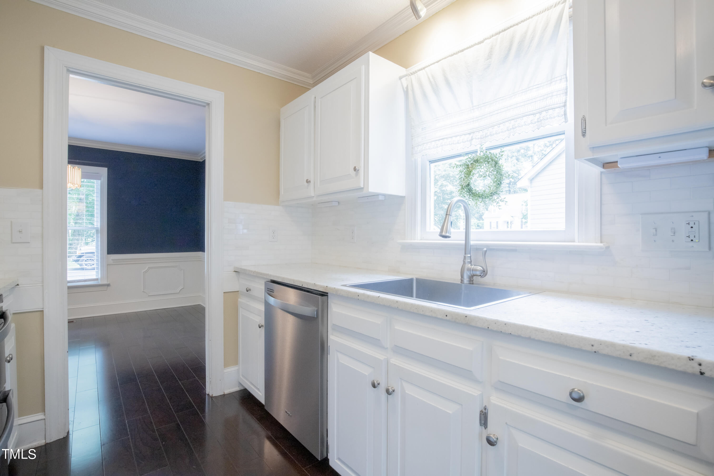 7012 Sandringham Drive Raleigh, NC 27613 - Photo 14 of 46 a kitchen with a sink cabinets and window