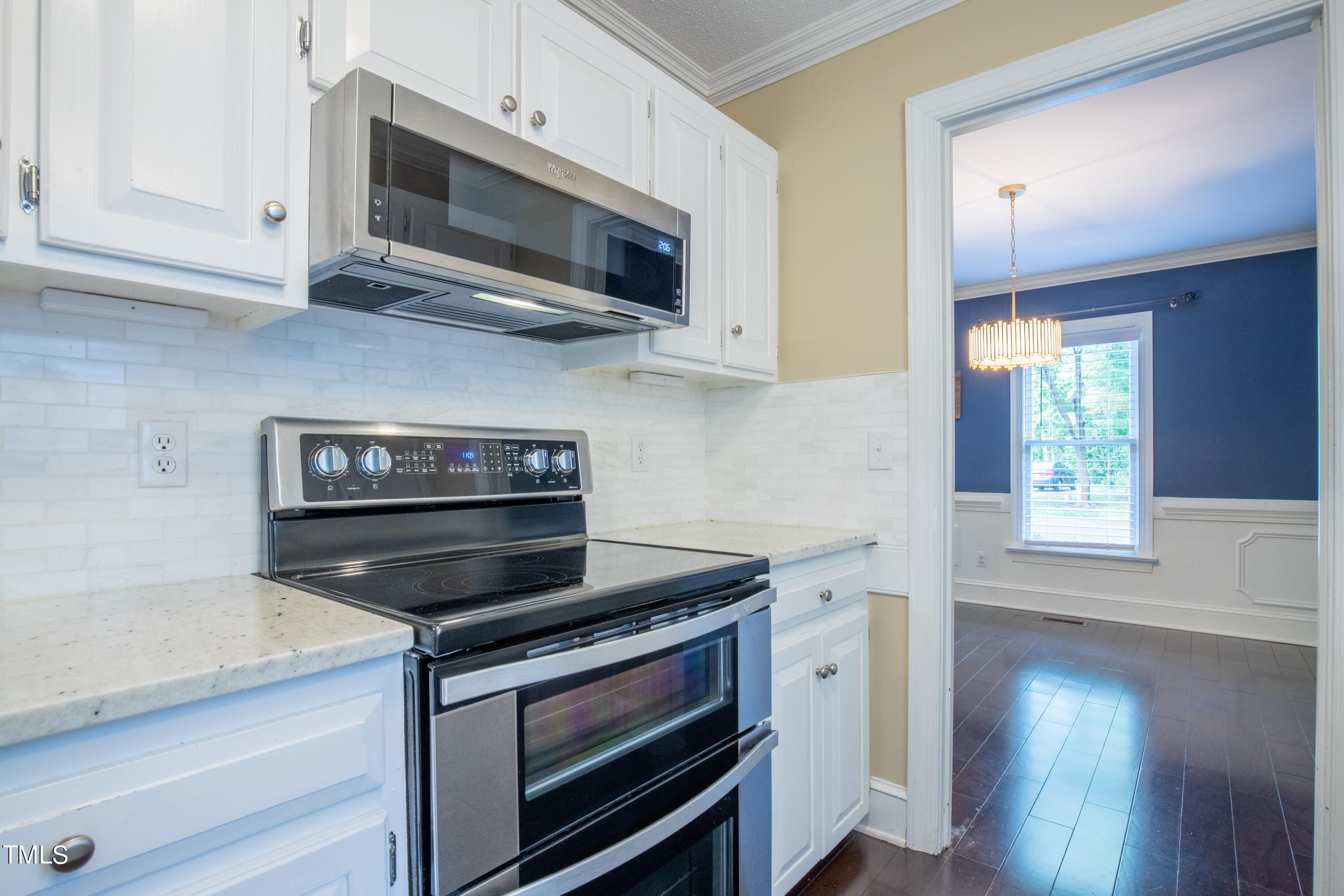 7012 Sandringham Drive Raleigh, NC 27613 - Photo 15 of 46 a kitchen with stainless steel appliances granite countertop a stove microwave and sink