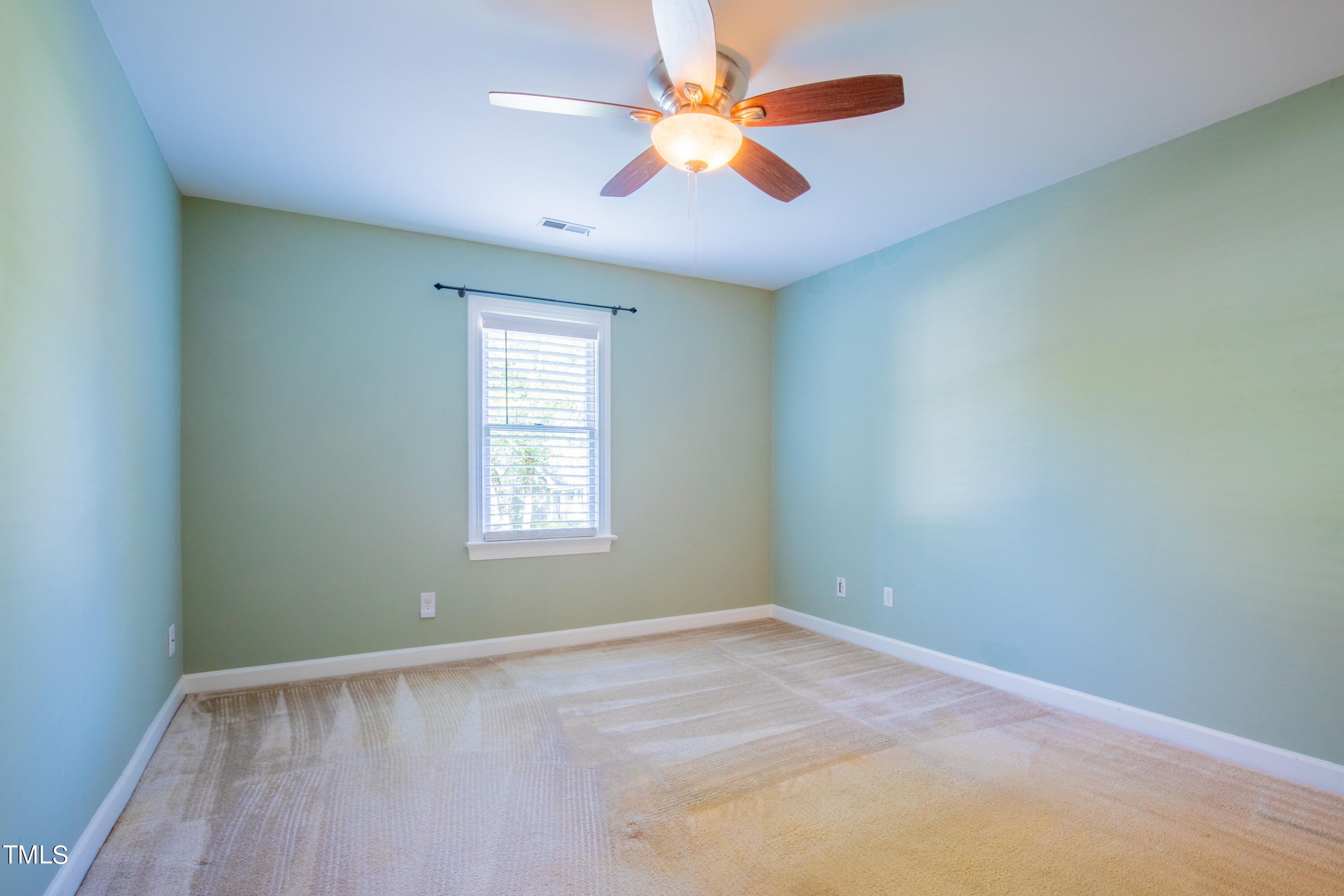 7012 Sandringham Drive Raleigh, NC 27613 - Photo 18 of 46 an empty room with windows and fan