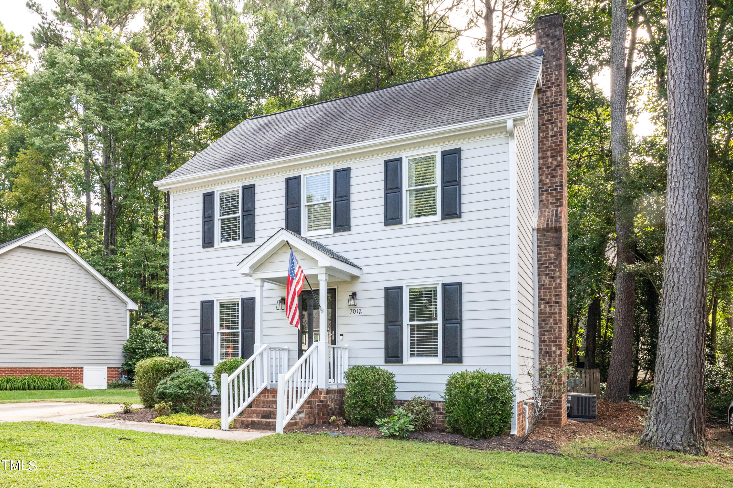 7012 Sandringham Drive Raleigh, NC 27613 - Photo 2 of 46 a front view of a house with a yard and garage