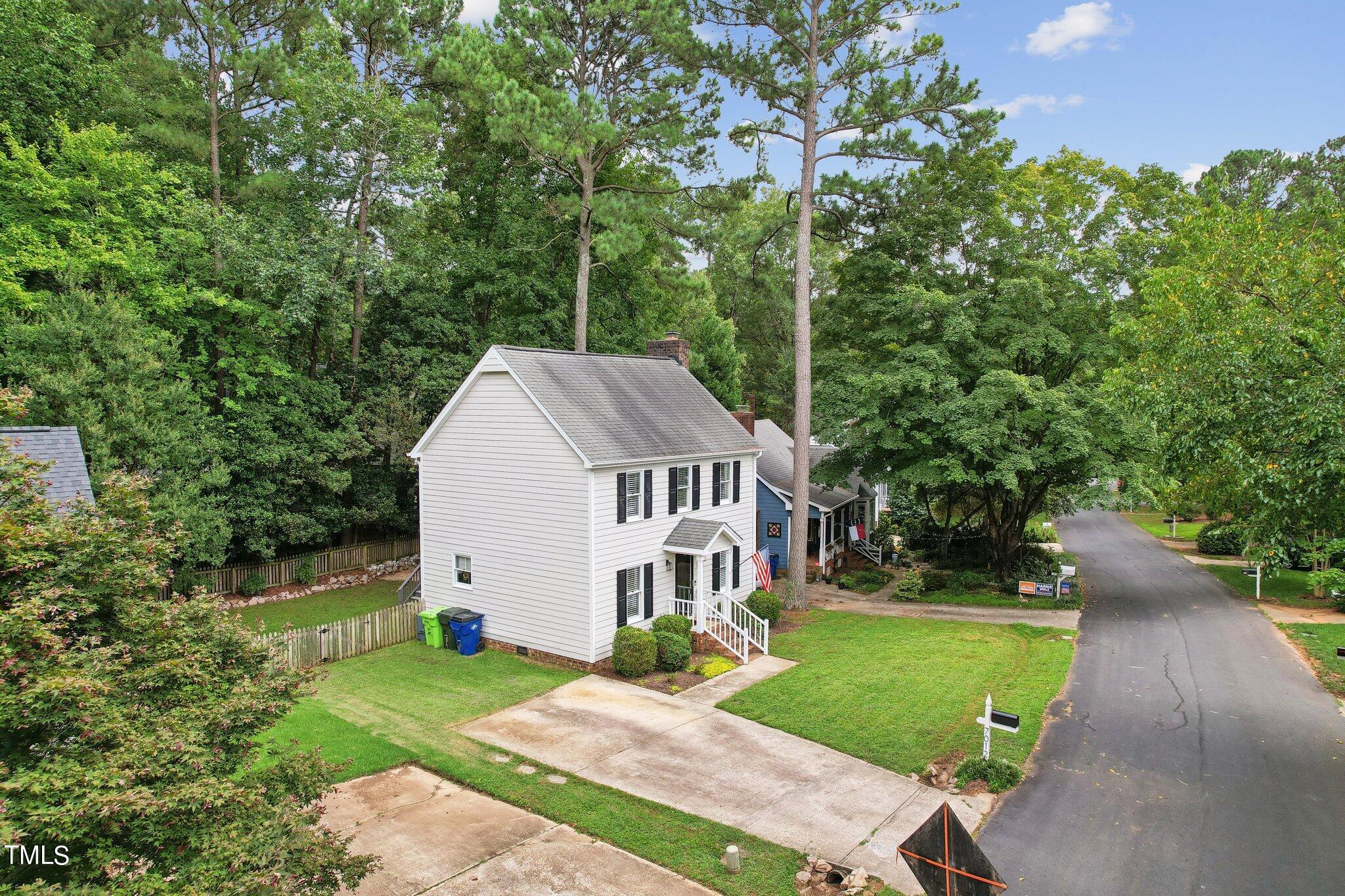 7012 Sandringham Drive Raleigh, NC 27613 - Photo 37 of 46 a view of a house with a big yard plants and large trees