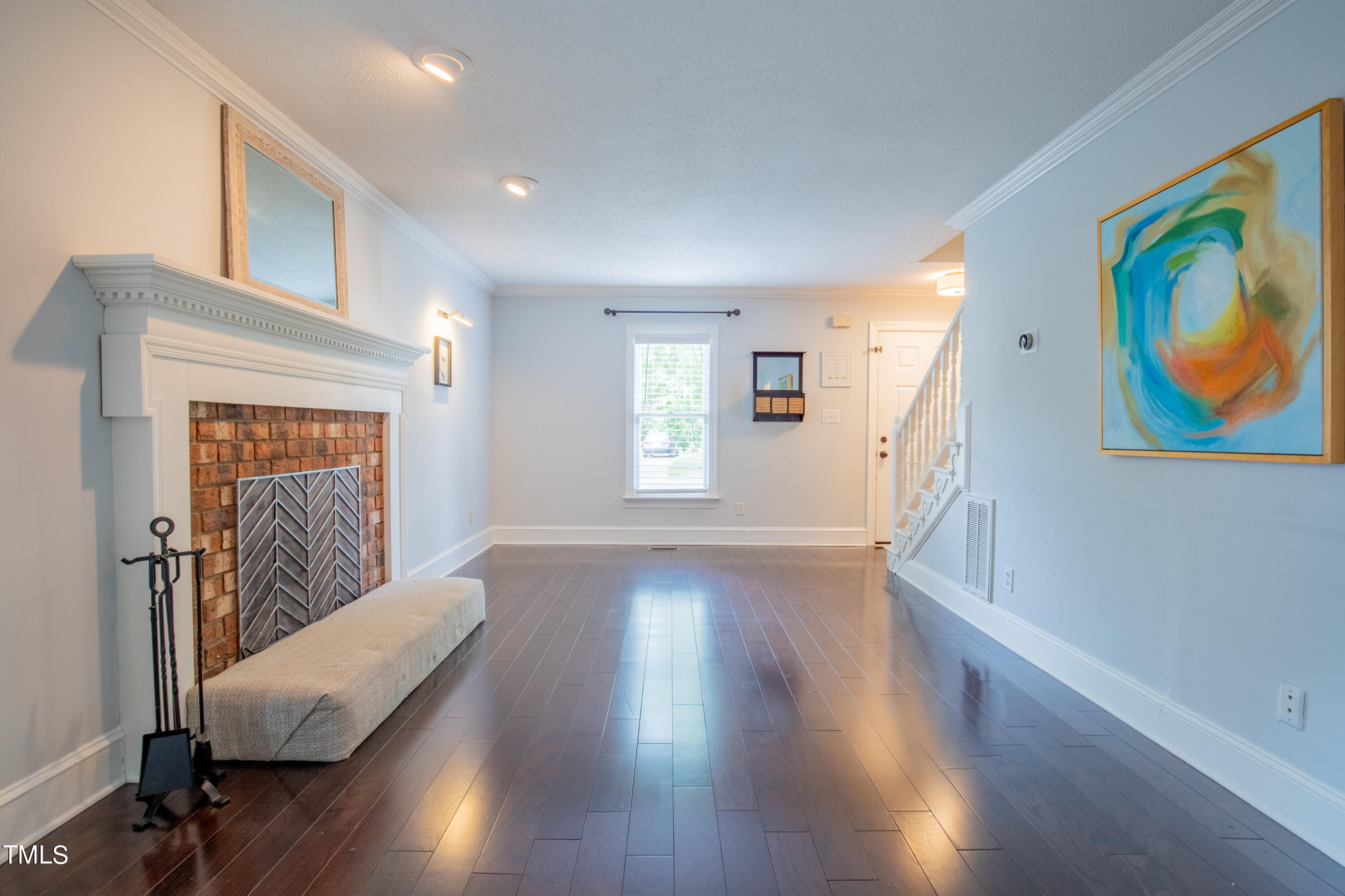 7012 Sandringham Drive Raleigh, NC 27613 - Photo 10 of 46 a view of a hallway with wooden floor and furniture