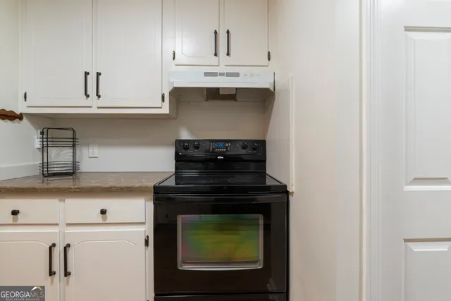 a stove top oven sitting inside of a kitchen