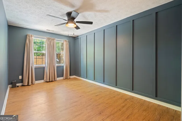 a view of a livingroom with a ceiling fan and window