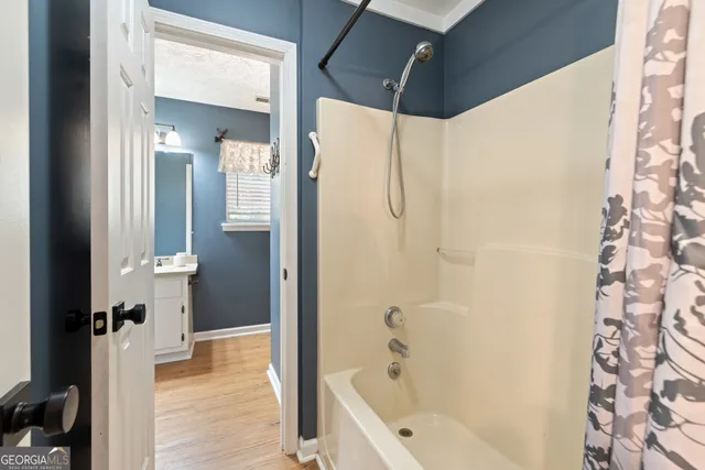 a bathroom with a bathtub and a shower