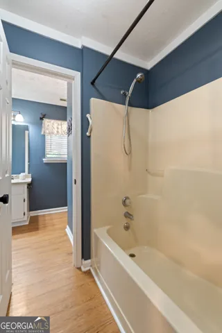 a bathroom with a bathtub and a shower