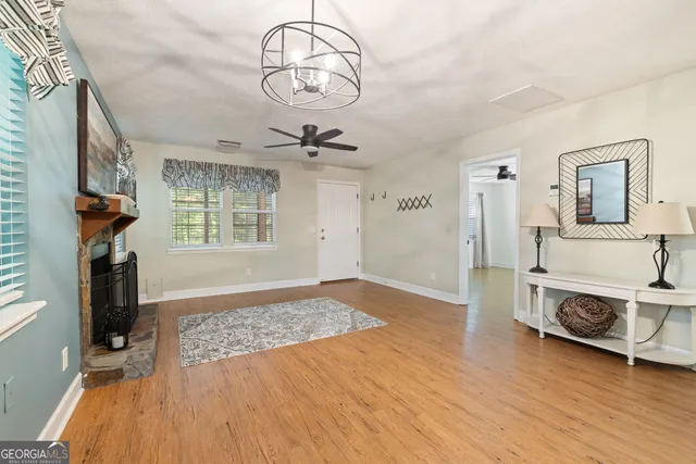 a view of a livingroom with wooden floor and a large window