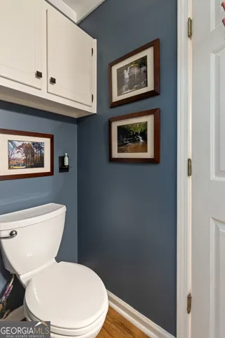a white toilet sitting next to a bathroom sink