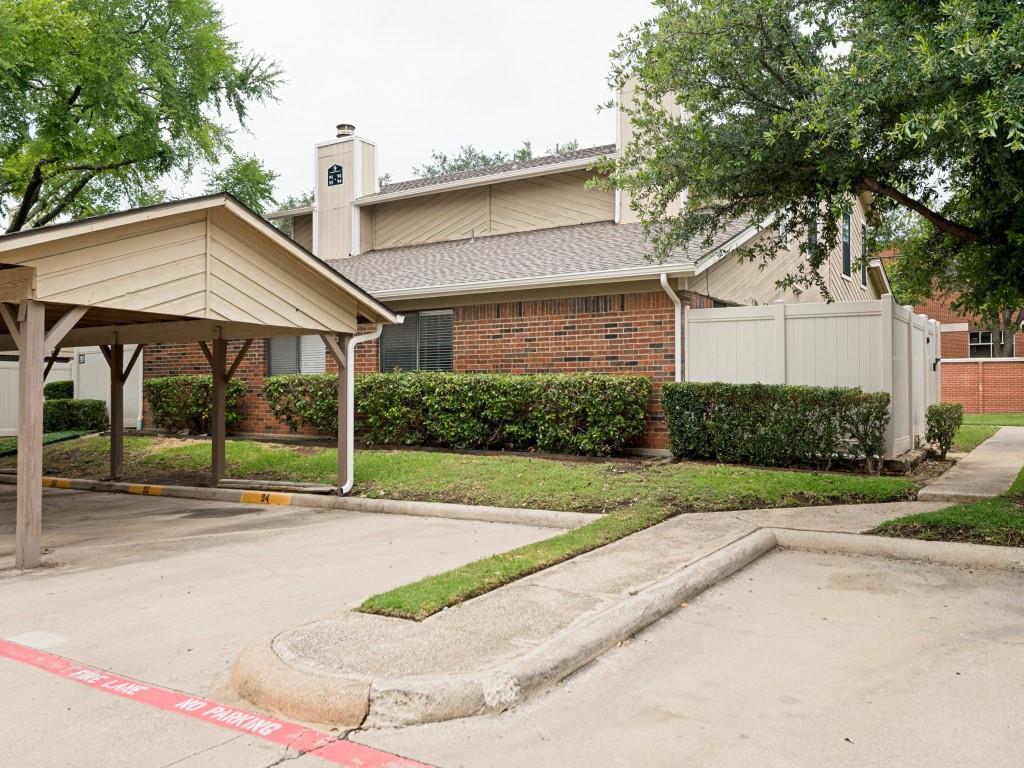 2240 Tarpley Road, Unit 92 Carrollton, TX 75006 - Photo 20 of 22 a view of a house with a yard and table and chairs under an umbrella