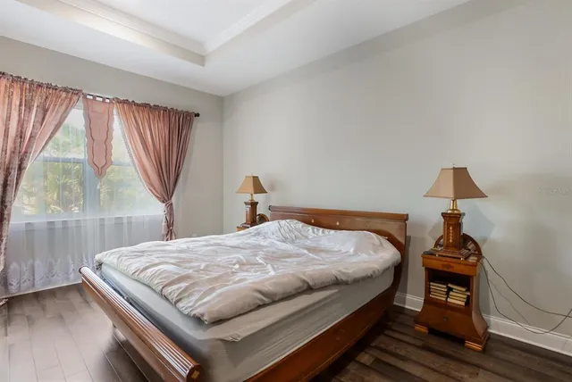 a bed sitting in a bedroom next to a window