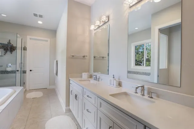 a spacious bathroom with a double vanity sink mirror double and shower