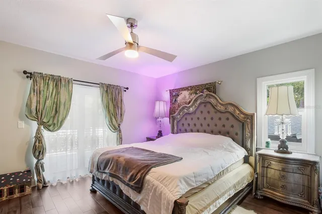 a bedroom with a bed a chandelier and dresser