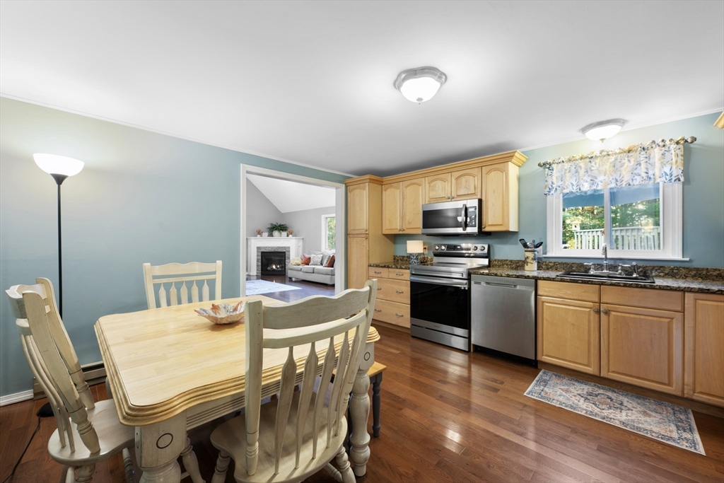 42 Breakneck Road Sturbridge, MA 01566 - Photo 11 of 35 a kitchen with granite countertop a stove a sink a dining table and chairs