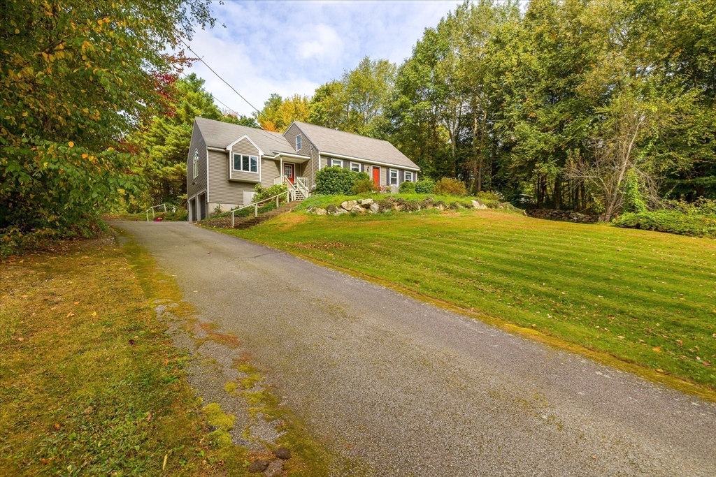 42 Breakneck Road Sturbridge, MA 01566 - Photo 23 of 35 a front view of a house with a yard and trees